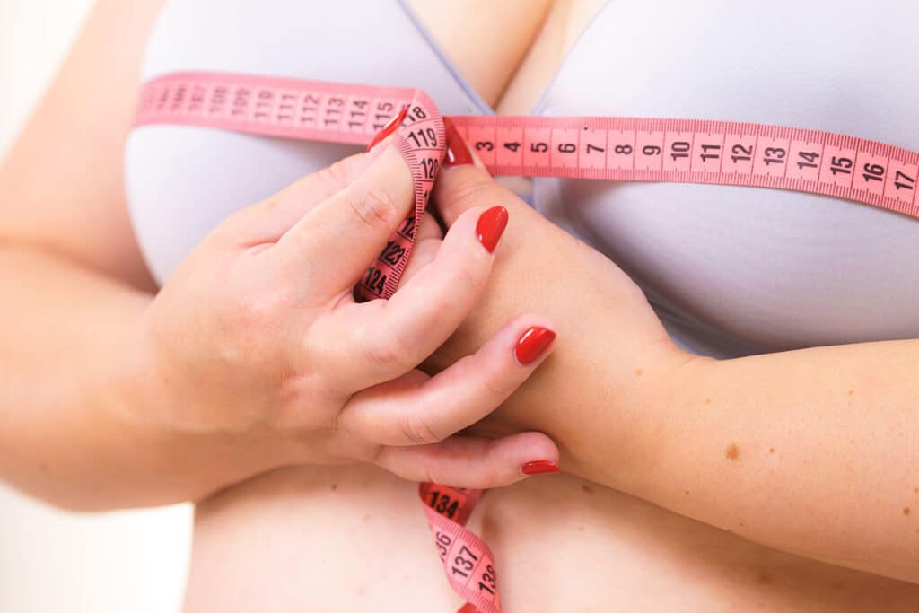 Close up to the breast of a female patient who considers having a breast reduction procedure in New York.