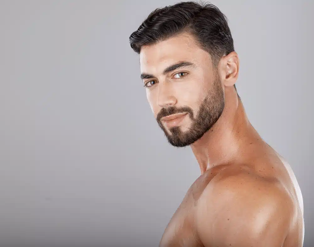 Muscular man with defined jawline and chin, showing results of male chin augmentation for facial balance.