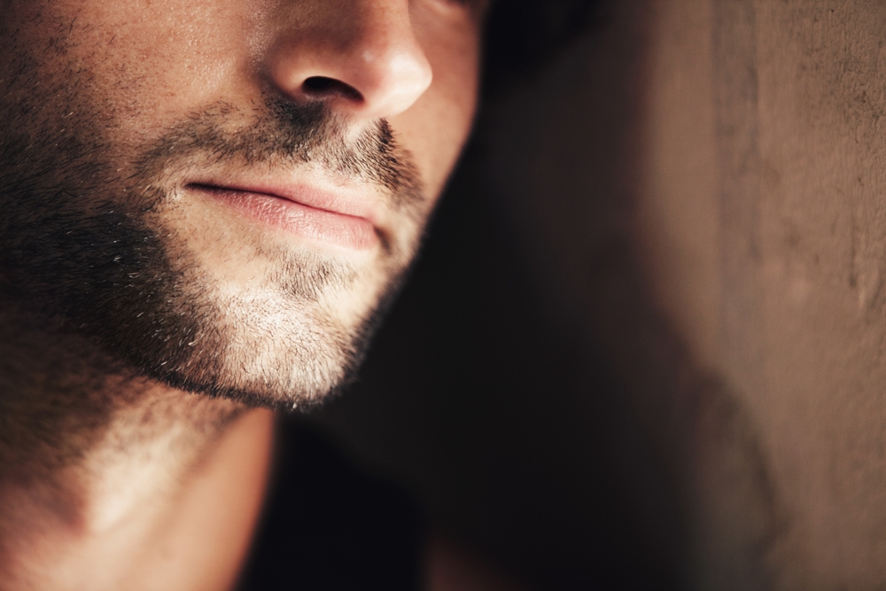Close-up of male jawline beside recovery guidance for jawline recontouring with injectable fillers.