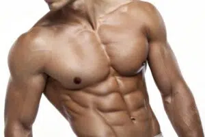 Cropped male torso showing defined chest muscles for pectoral implants versus fat grafting comparison
