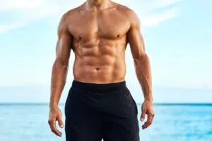 Athletic male torso beside text explaining VASER lipo for men’s waist and abdominal definition